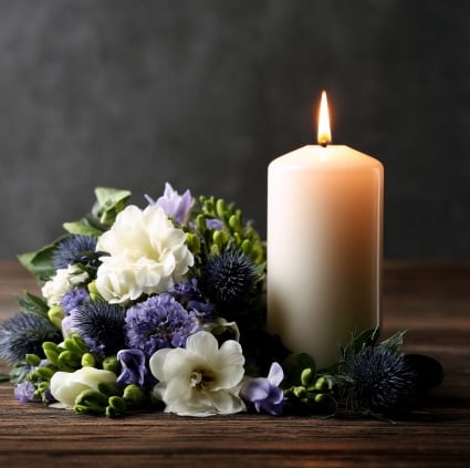 Memorial candle with flowers representing cremation services in Little Elm, TX.