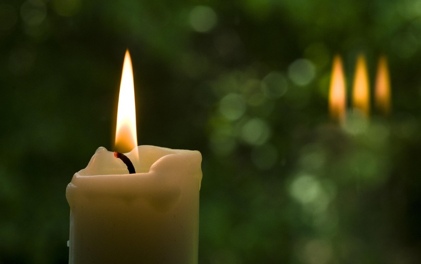 Lit memorial candle representing remembrance and tribute in Little Elm, TX.